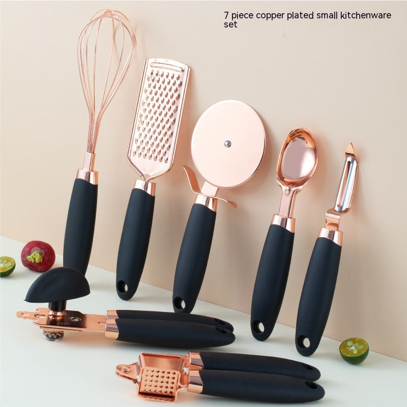 Rose gold copper plating kitchen tool set including peeler, grater, whisk, and can opener with black handles. Durable and elegant kitchen gadget.